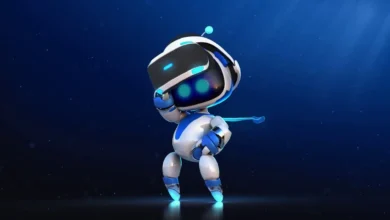 Astro Bot, the adorable PlayStation mascot, stands in a playful pose against a starry blue background, showcasing its sleek white and blue robotic design with glowing eyes.